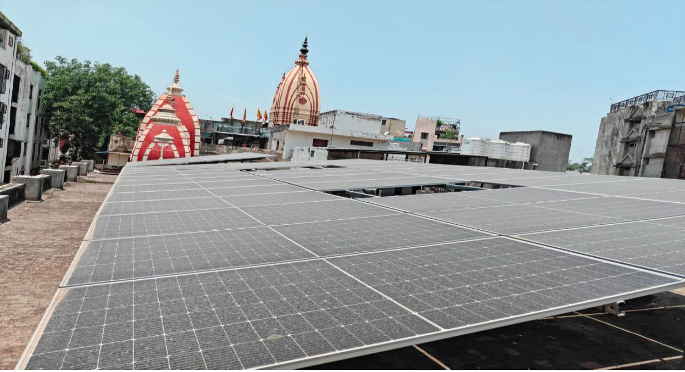 Solar panels installed on the temple roof, with the temple spires in the background