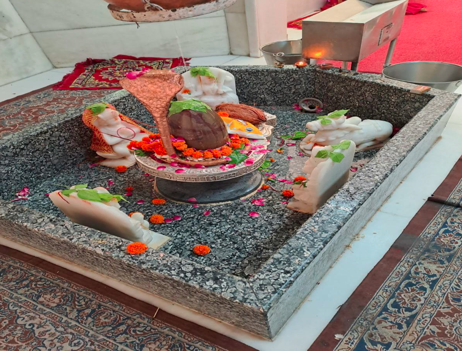 Shivling in its stone basin, where the water offered is collected and returned to the earth